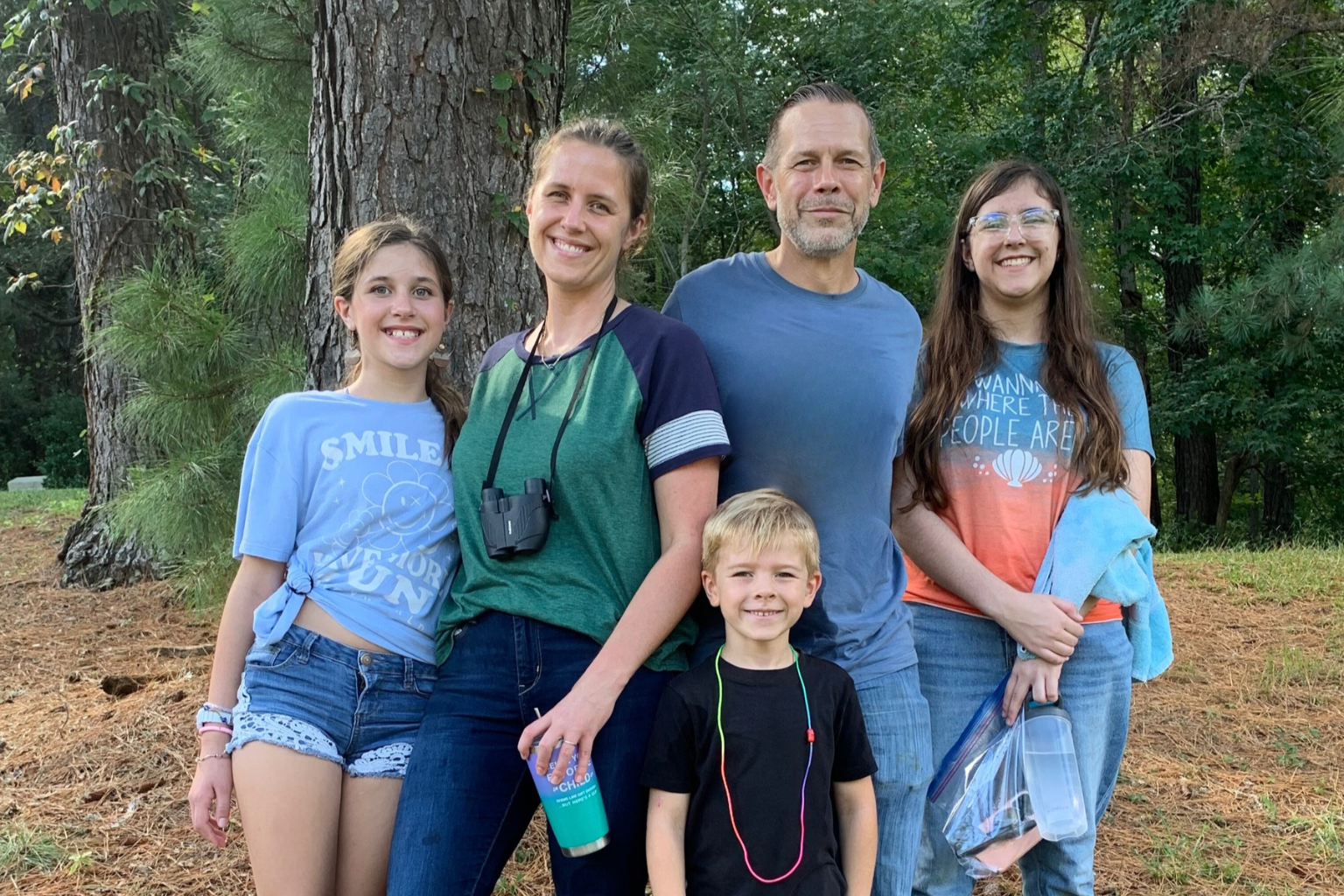 Shane Brazzell and his family surrounded by trees after kayaking at Northwest River State Park in Chesapeake, VA