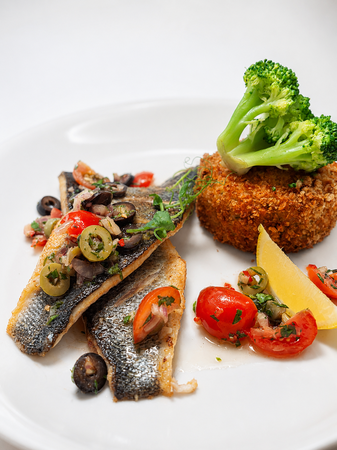 Sea Bass served with our tomato and caper Mediterranean Salsa and a Spinach and Parmesan Croquette. 