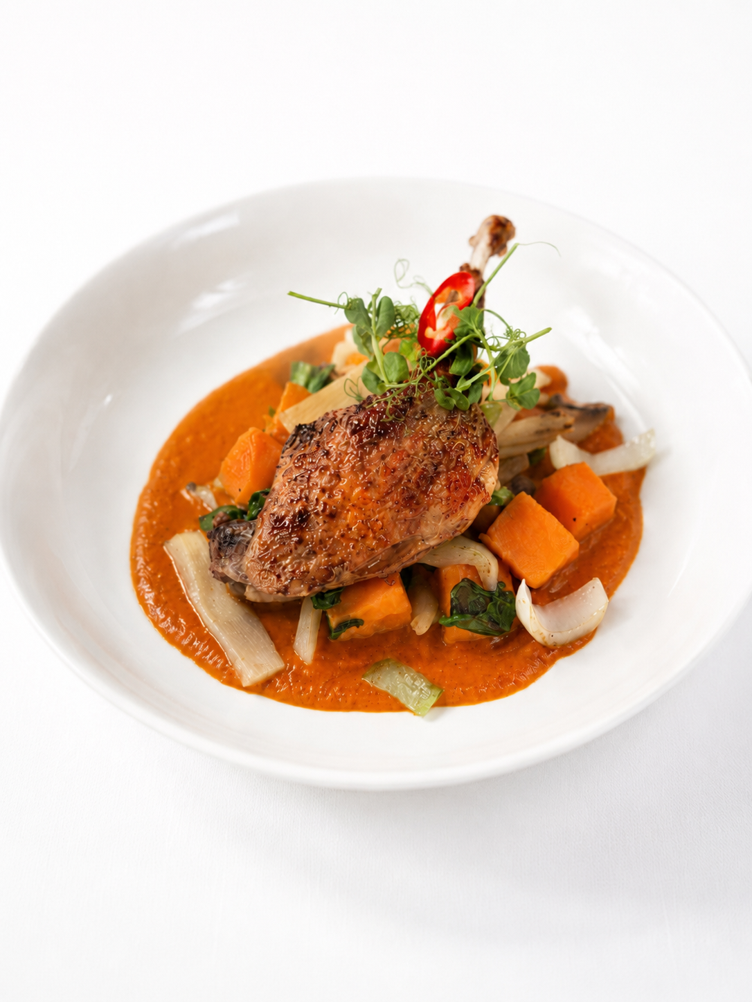Confit Duck Leg, served with Sweet Potato, Bamboo Shoots, Spinach, Mushroom and Tom Yum sauce.