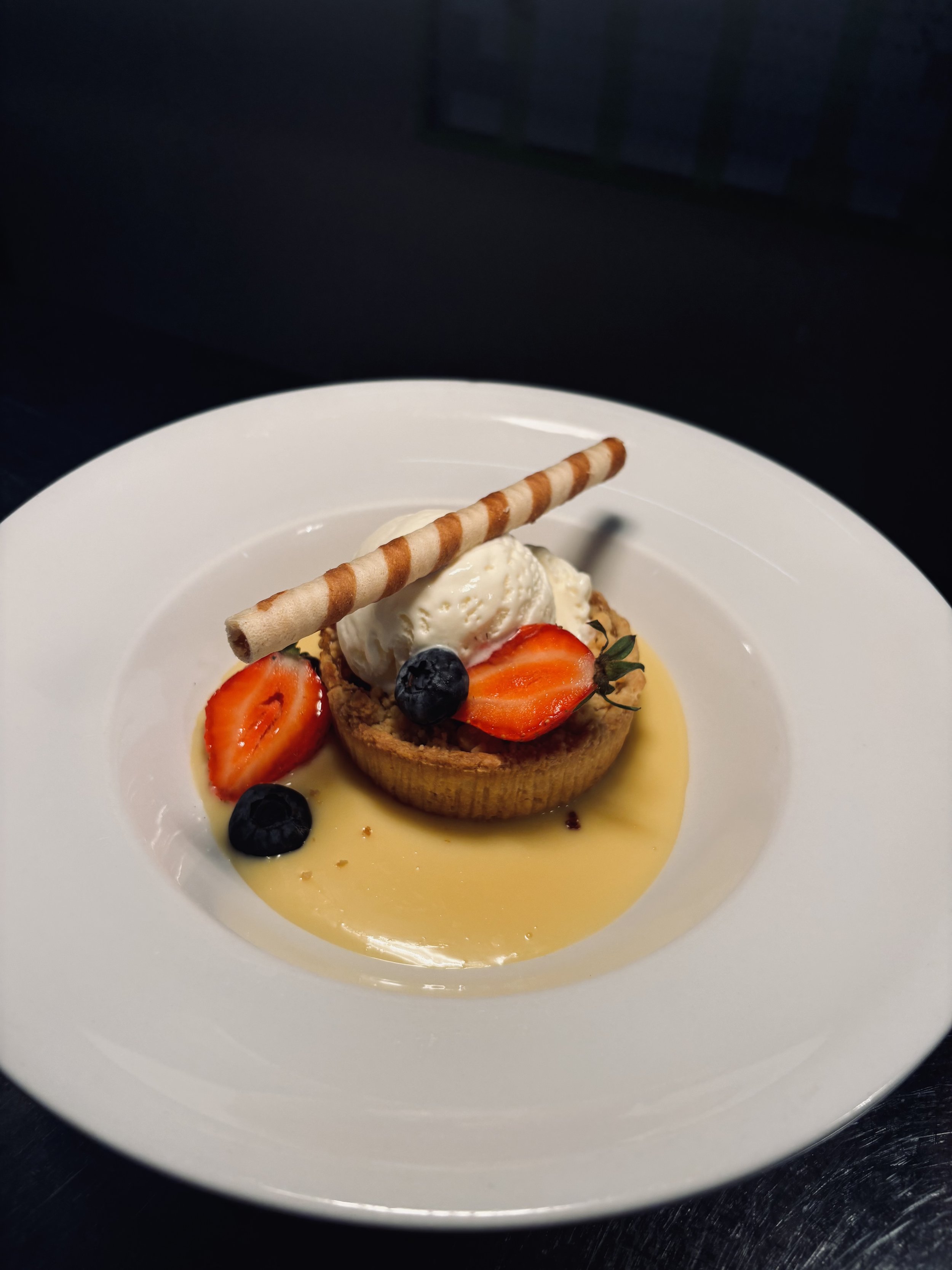 Homemade Apple and Fresh fruit Crumble served with warm custard.