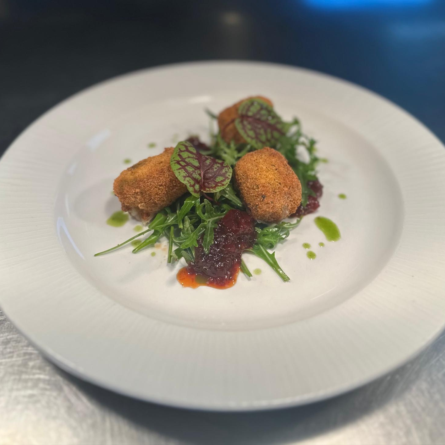 Panko Breaded Brie Wedges with a Tomato Chutney, Rocket and Herb Oil