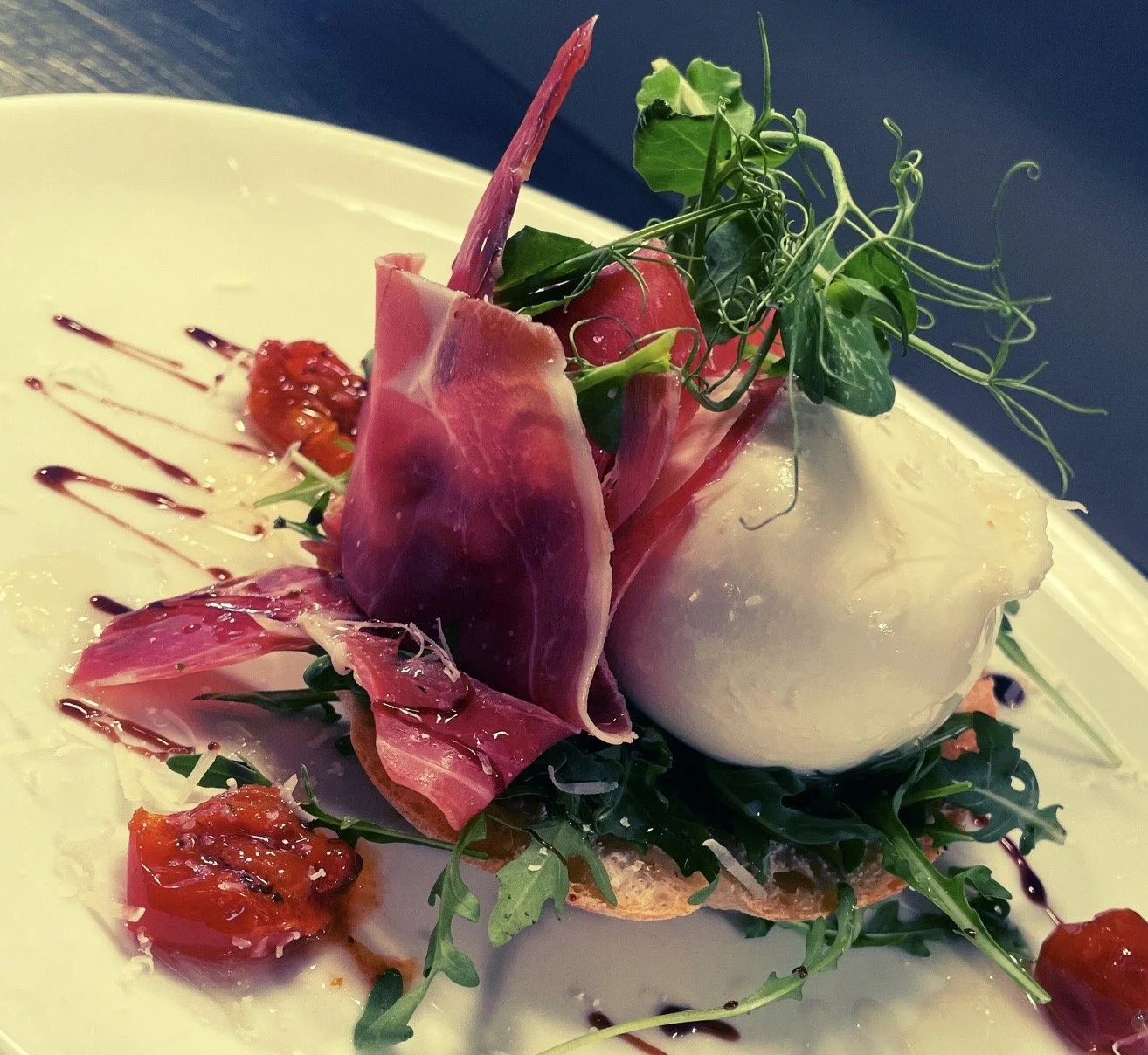 Italian Buratta, Parma Ham, Confit Tomato on Garlic Focaccia Bread.