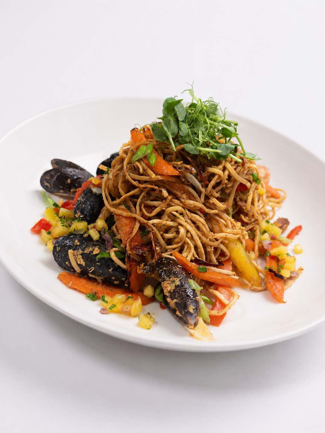 Seafood Egg Noodle Stir Fry topped with a Mango and Red Pepper Salsa.