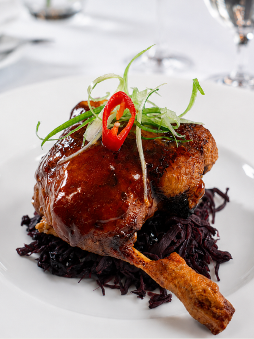 Confit Leg of Silverhill Duck, Glazed in a Plum Sauce served on a bed of Braised Red Cabbage.