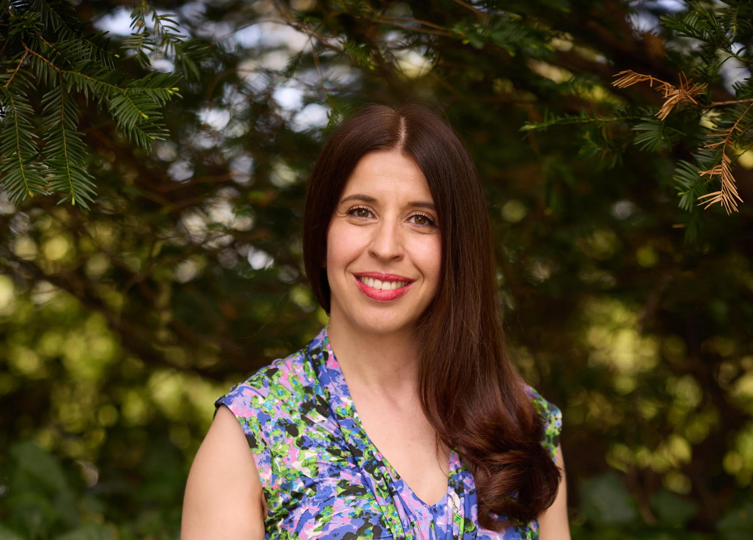 Ana, a therapist in New york, smiling empathetically at camera