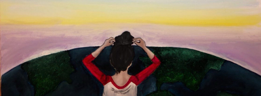 Person sitting on a grassy hilltop at sunset, looking at the sky with hands on their head.