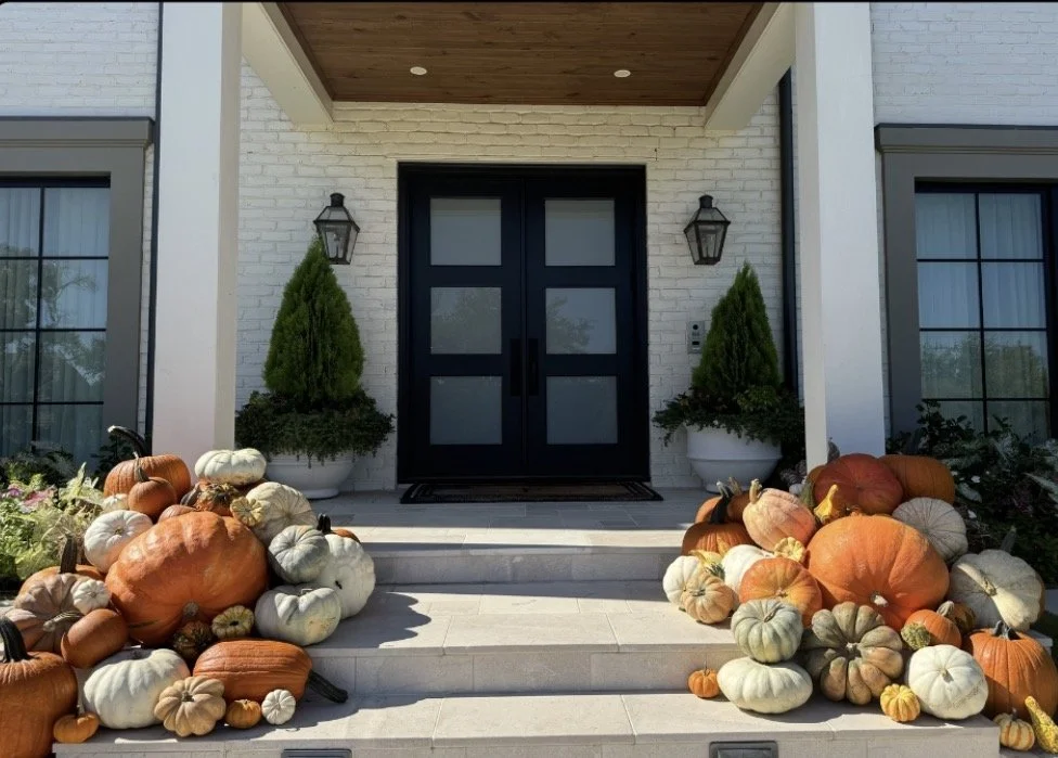 Fall autumn decorated front porch with pumpkins and gourds