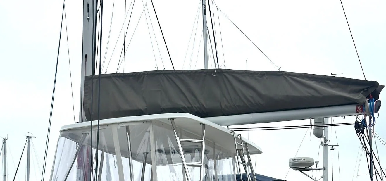 Close-up of sailboat rigging and equipment, including sails, masts, and navigation instruments.
