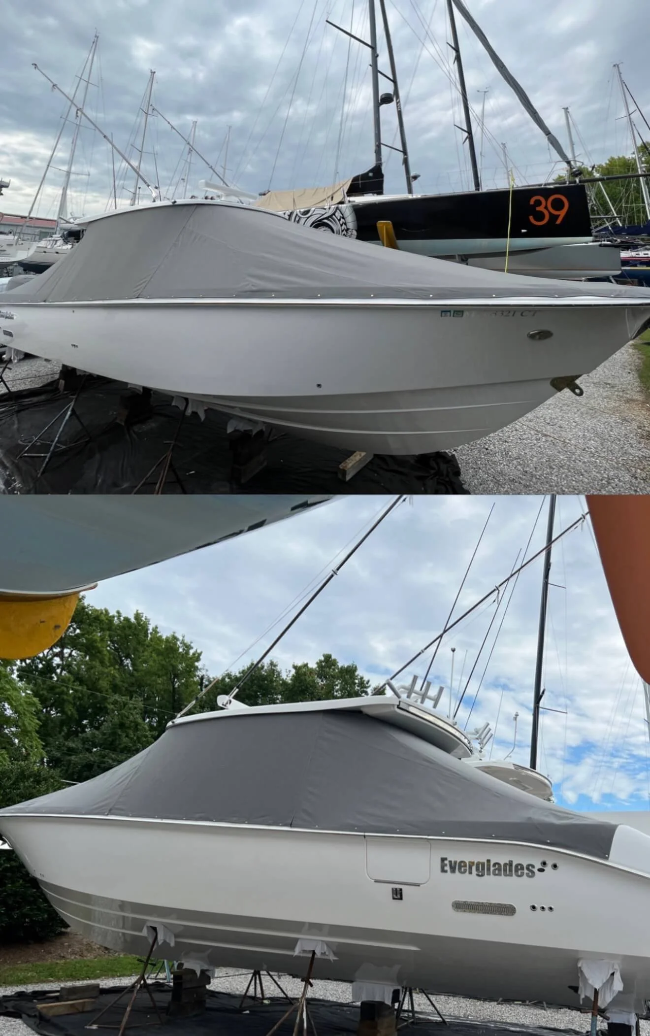 Two boats on land with covers, one named Everglades, with a cloudy sky and trees in the background.