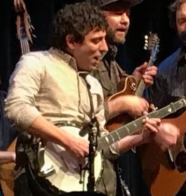 Group of musicians playing instruments on stage at a live performance