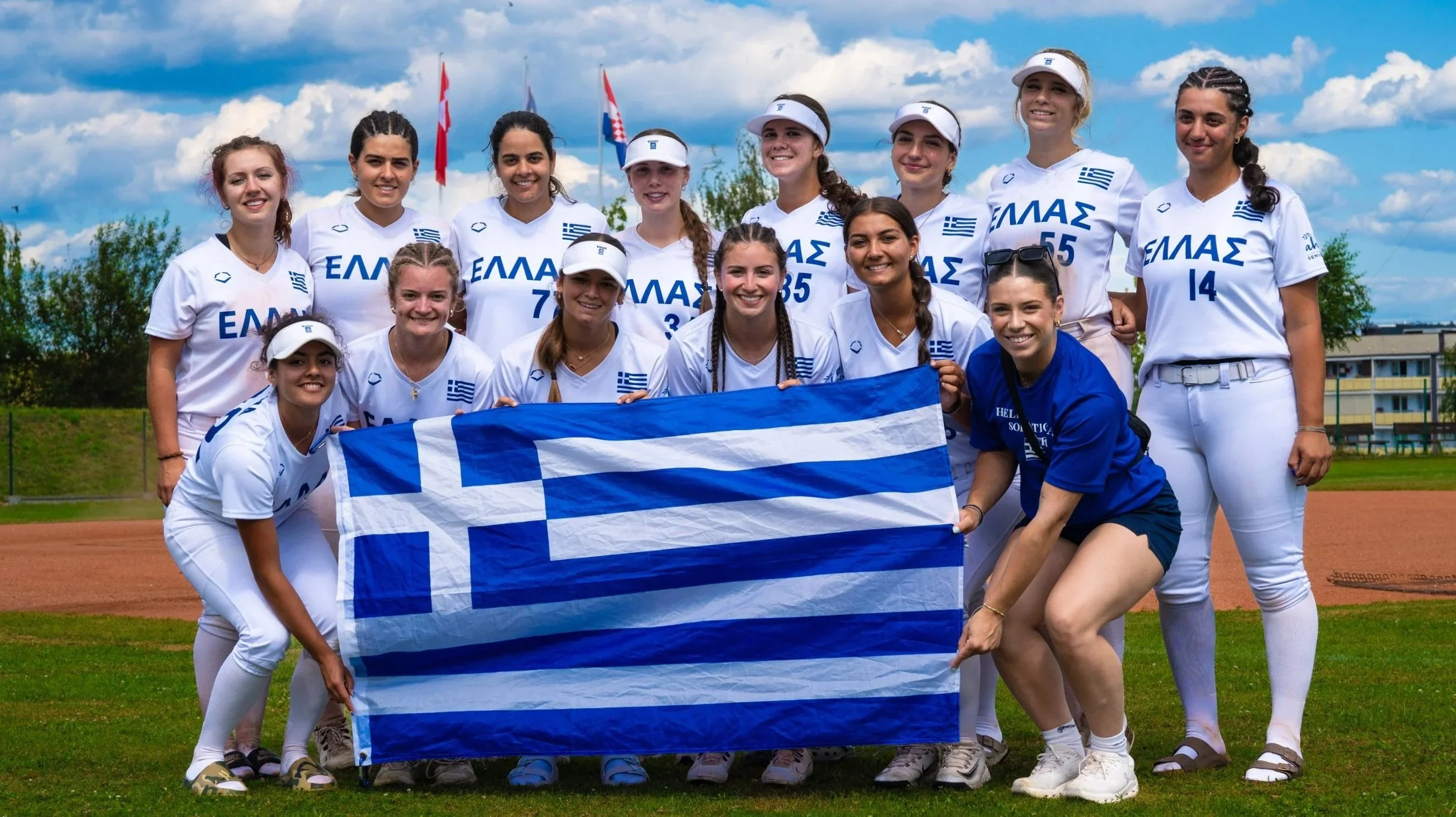 Hellas National Softball team holding the Greek flag at the WBSC Softball European Championship 2026