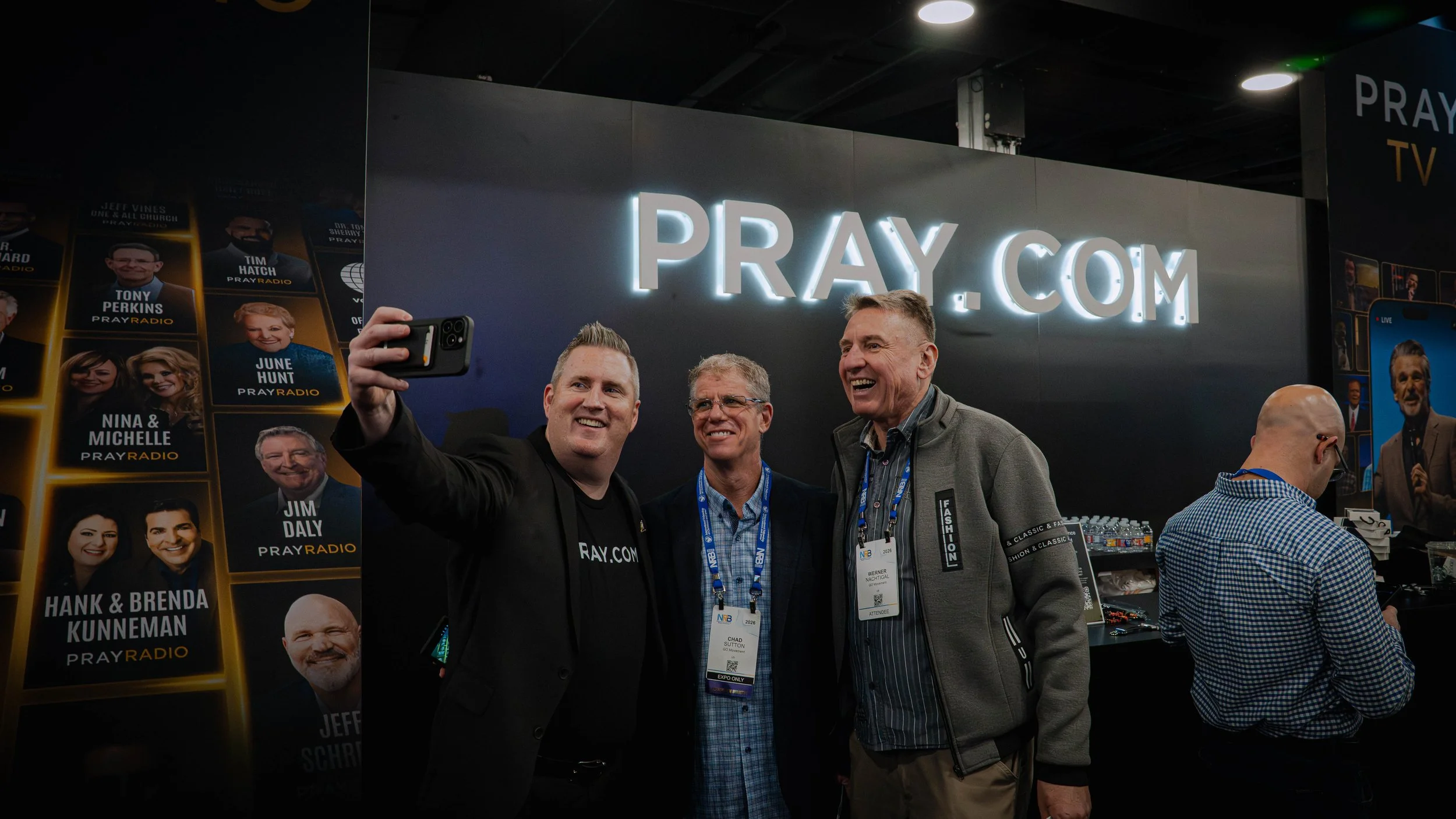 Visitors posting for a photo at the pray.com booth at NRB Conference 2026
