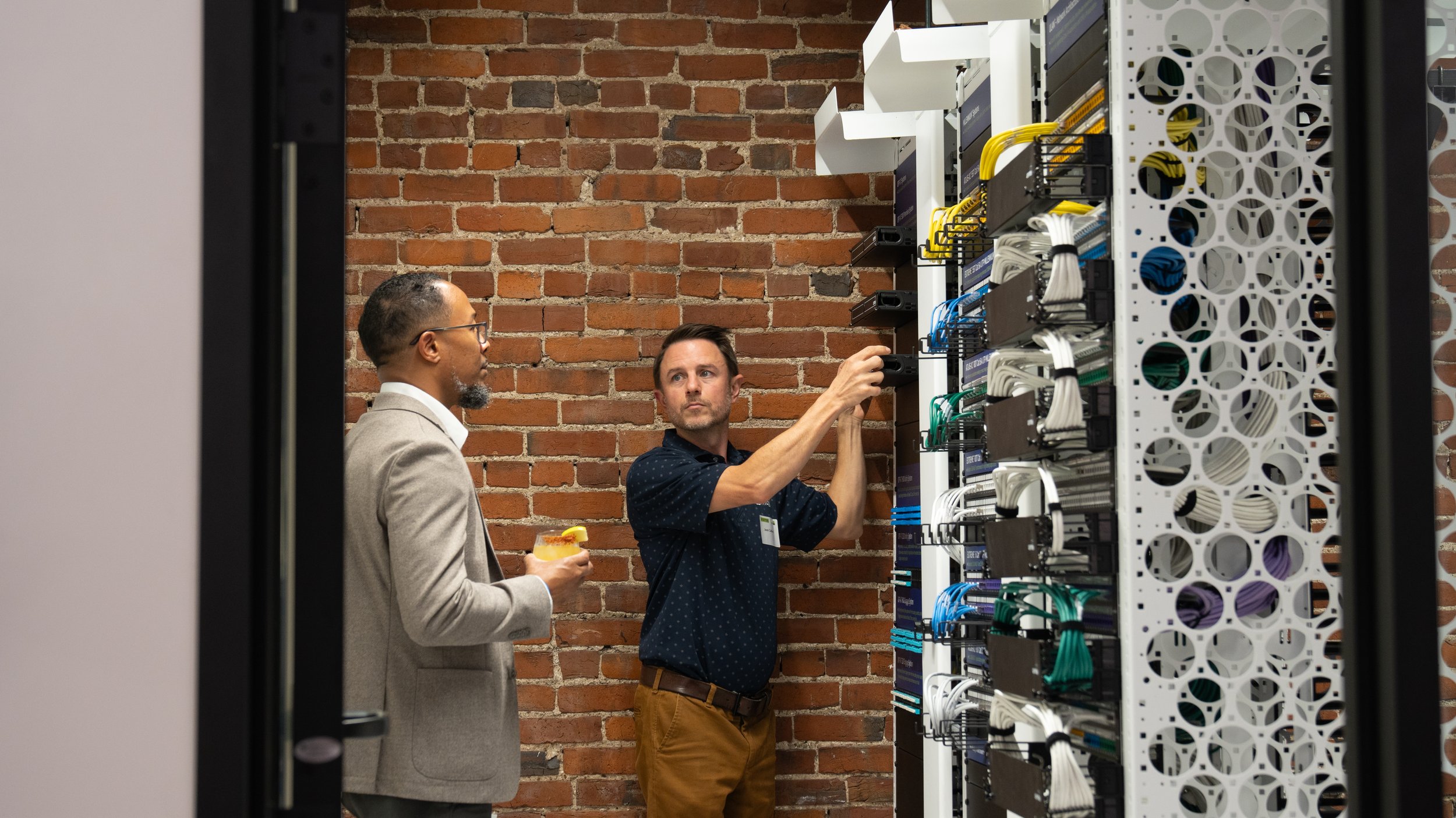 A Civic Design Center employee showcasing their technology to a community member at the Civic Design Center's 25th anniversary celebration