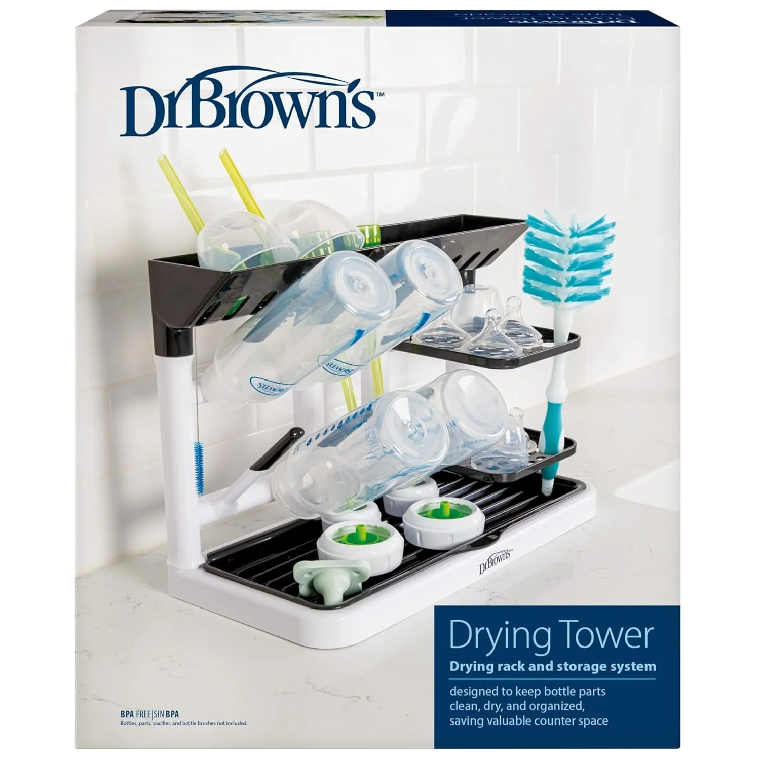 Packaging box for Dr. Brown's drying tower, a drying rack and storage system for baby bottles and parts, featuring a black rack with bottles and brush, white and green accessories, and a blue cleaning brush.