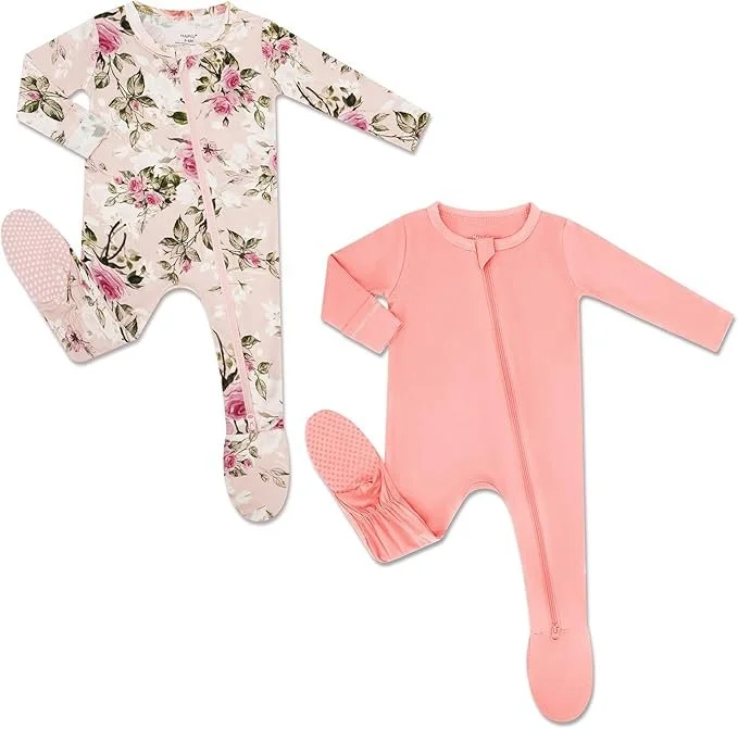 Two baby romper outfits, one floral with long sleeves and footed legs, the other solid pink with long sleeves and zipper closure, both designed for infants.