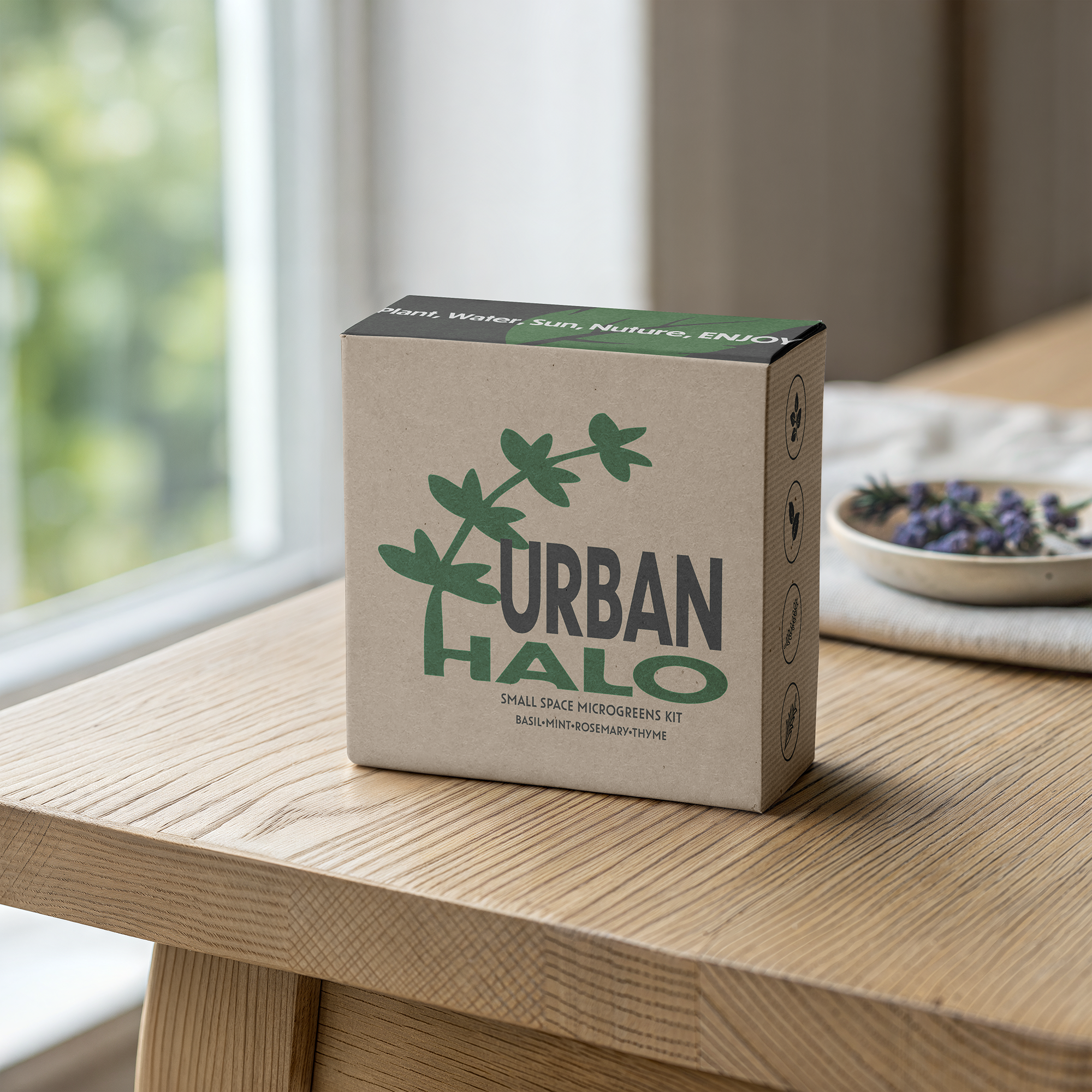 Close-up of a cardboard box labeled 'Urban Herb' with green leaf graphics, placed on a wooden surface near a window with blurred greenery outside.