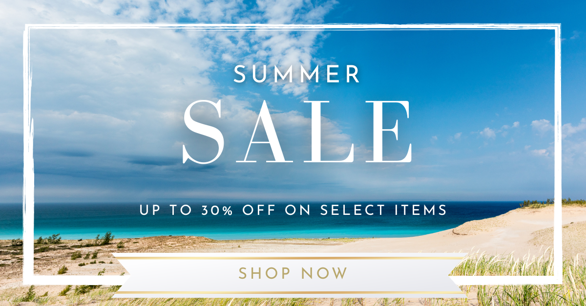 An ad banner that reads "Summer Sale: Up to 30% off on select items," placed over a beach scene with sand dunes, grasses, bright blue Lake Michigan waters, under a partly cloudy sky.