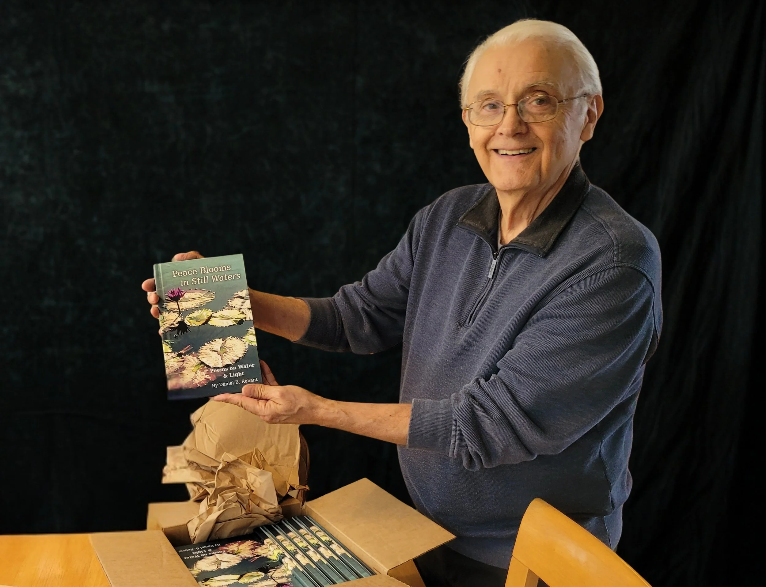 Poet unboxing his hardcover book - plain black background.jpg