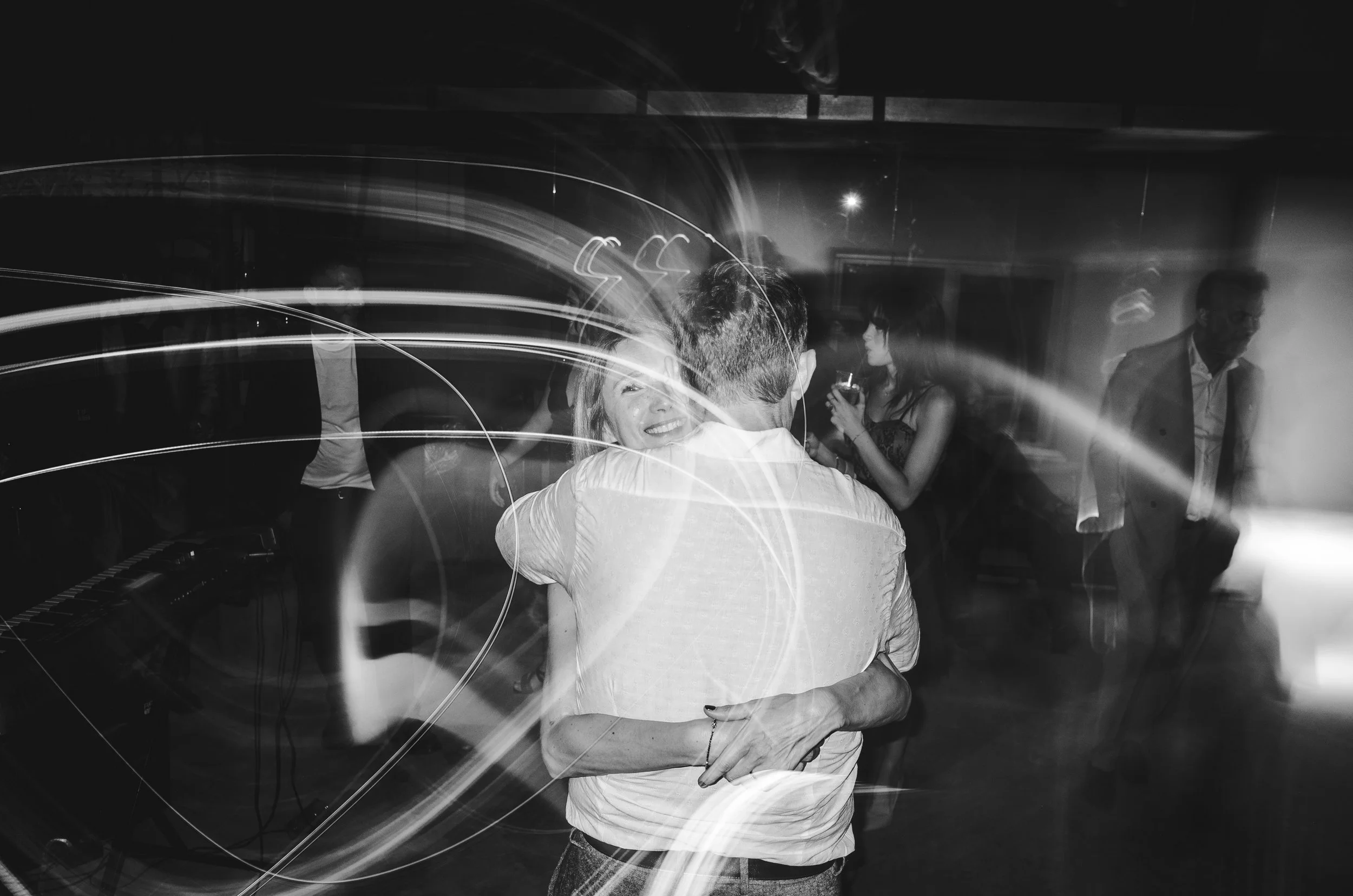 People dancing at a party or dance event with light trails from movement