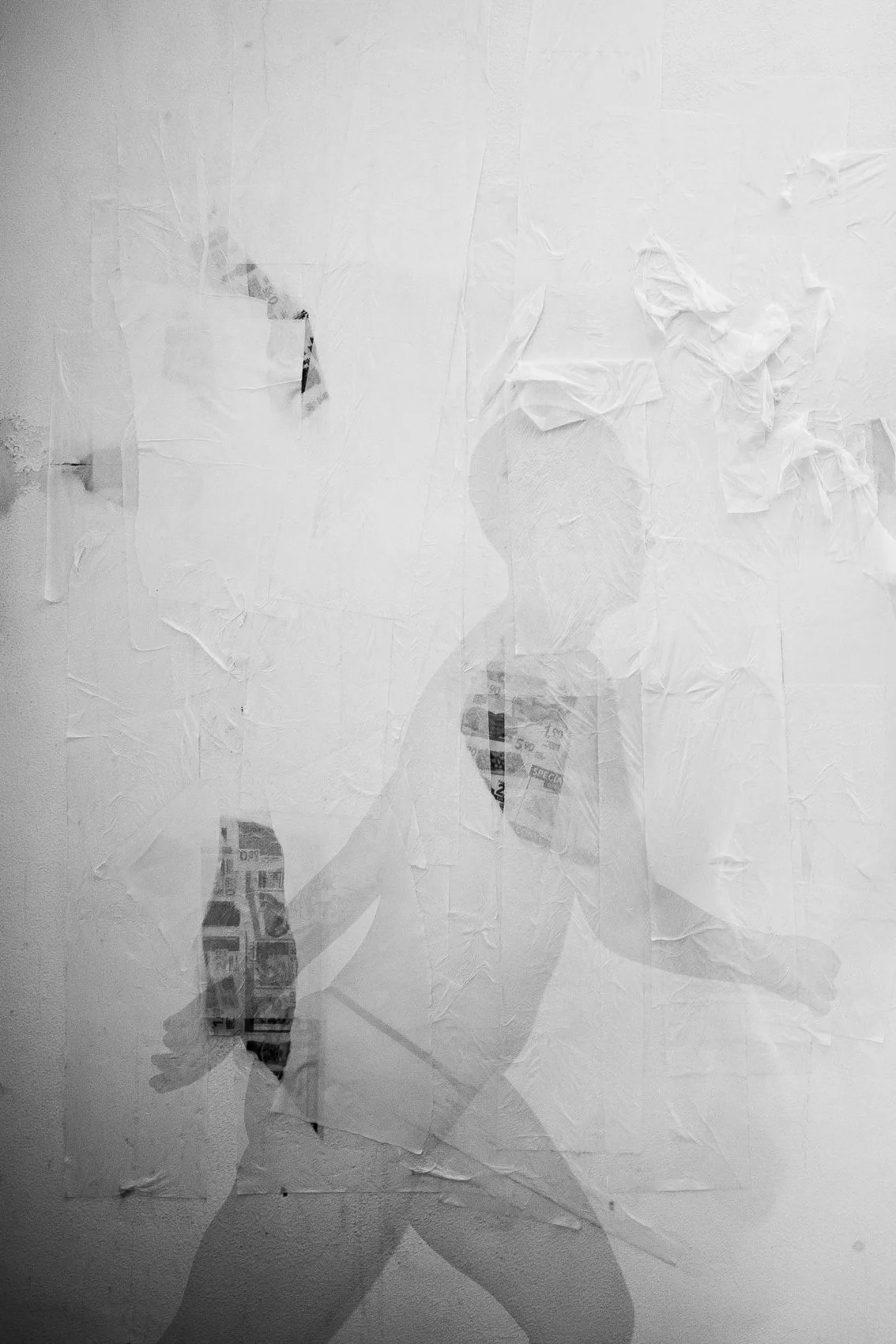 A black and white photograph of a person walking while holding a leash attached to a dog. The image appears to be a silhouette or shadow, with torn paper and newspaper scraps creating a layered textured effect.