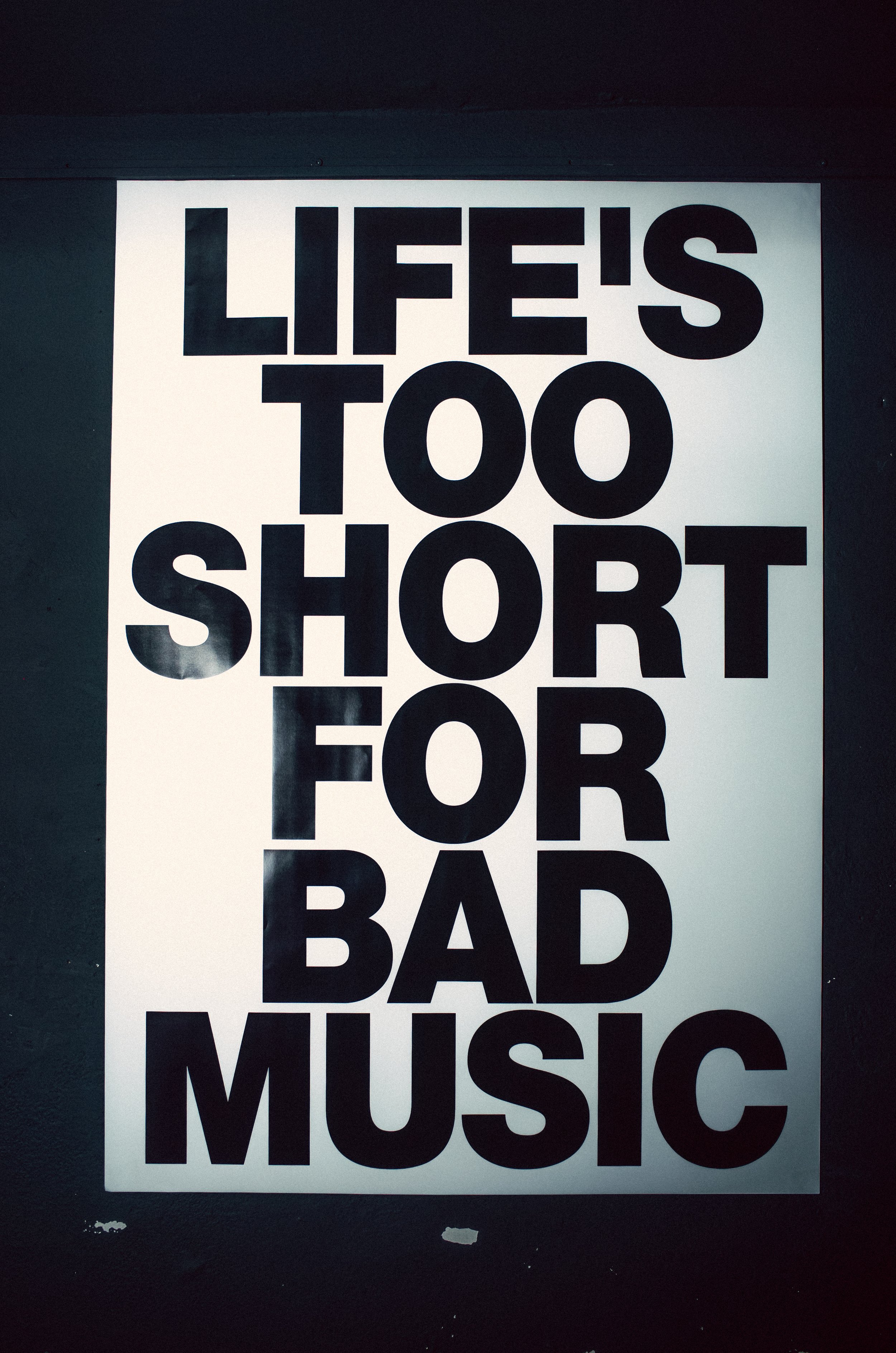 A poster with the text, 'LIFE'S TOO SHORT FOR BAD MUSIC' in large black letters on a white background.