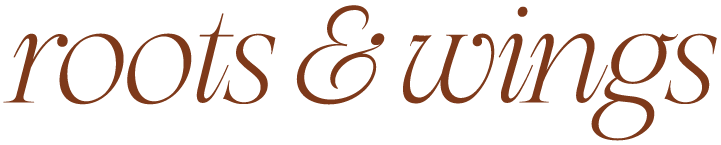 Text reading "roots & wings" in brown cursive font.
