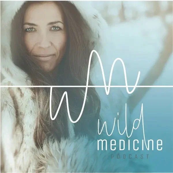 A woman with long brown hair in a winter coat with fur trim, outdoors near a body of water, with the title 'Wild Medicine Podcast' written across the image.
