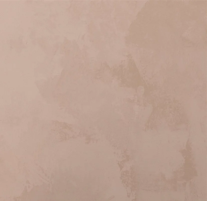 A plain beige or light pink wall with subtle textured patterns.