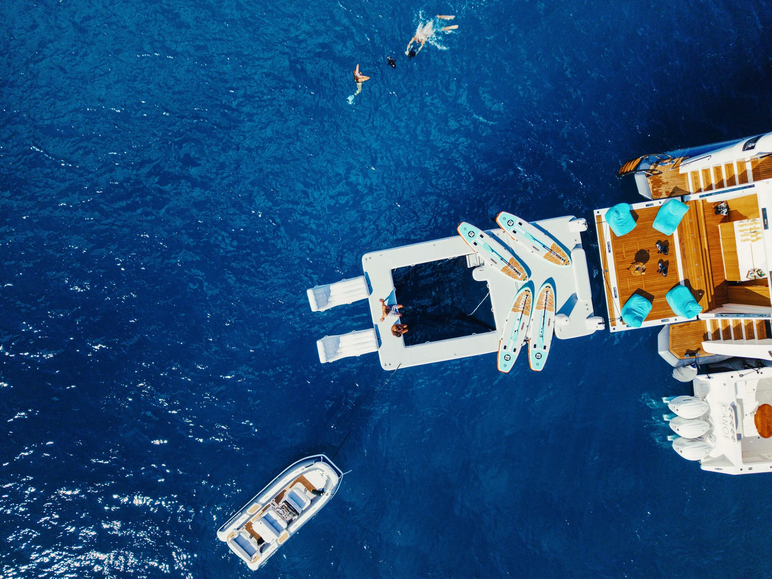 Luxury yacht aquabana setup with inflatable dock and water toys