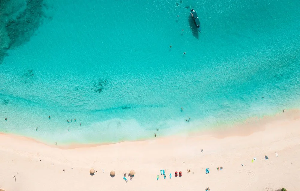 Turquoise Caribbean ocean water surrounding a luxury yacht destination