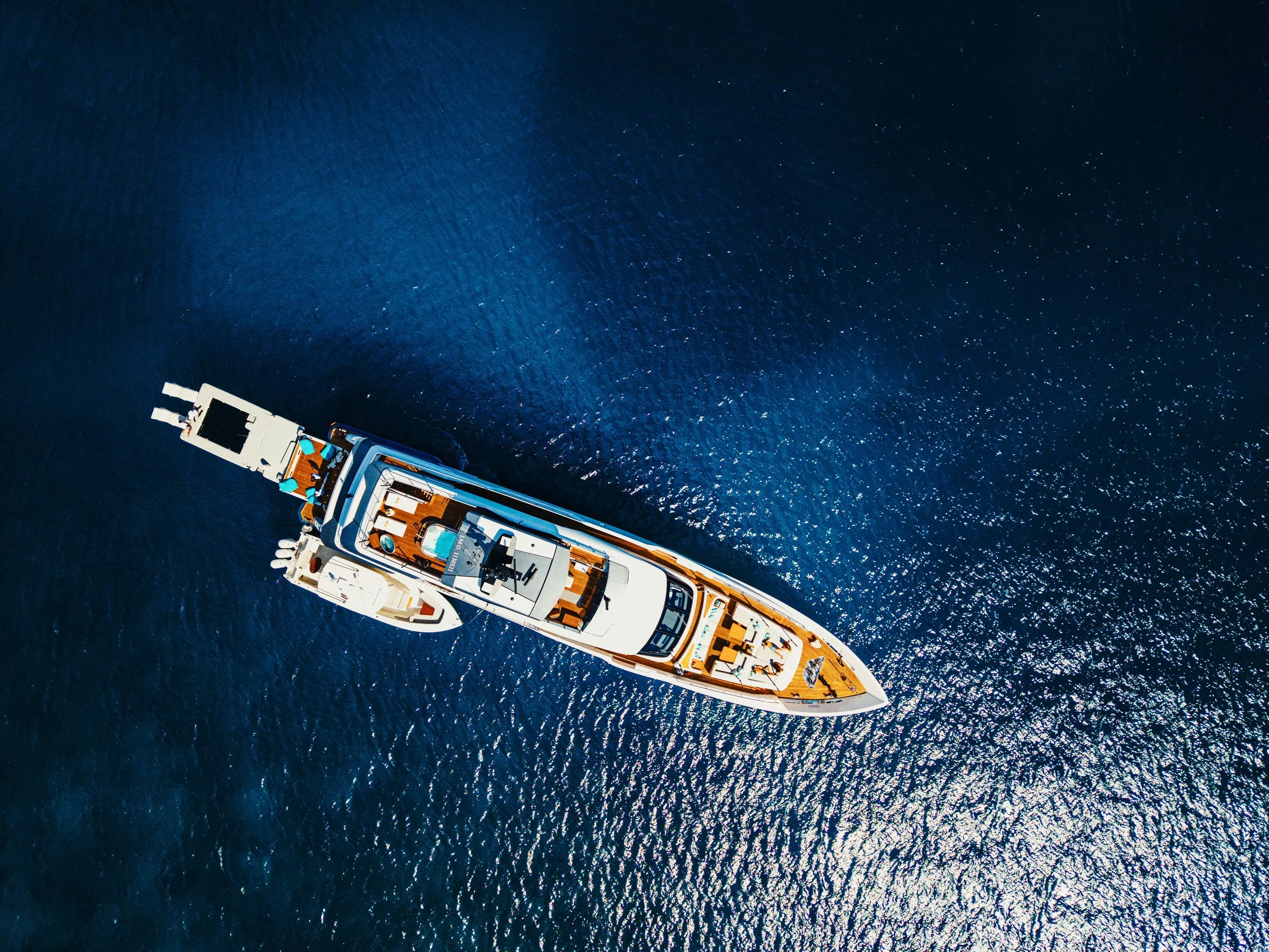 Drone shot of a luxury yacht with tender