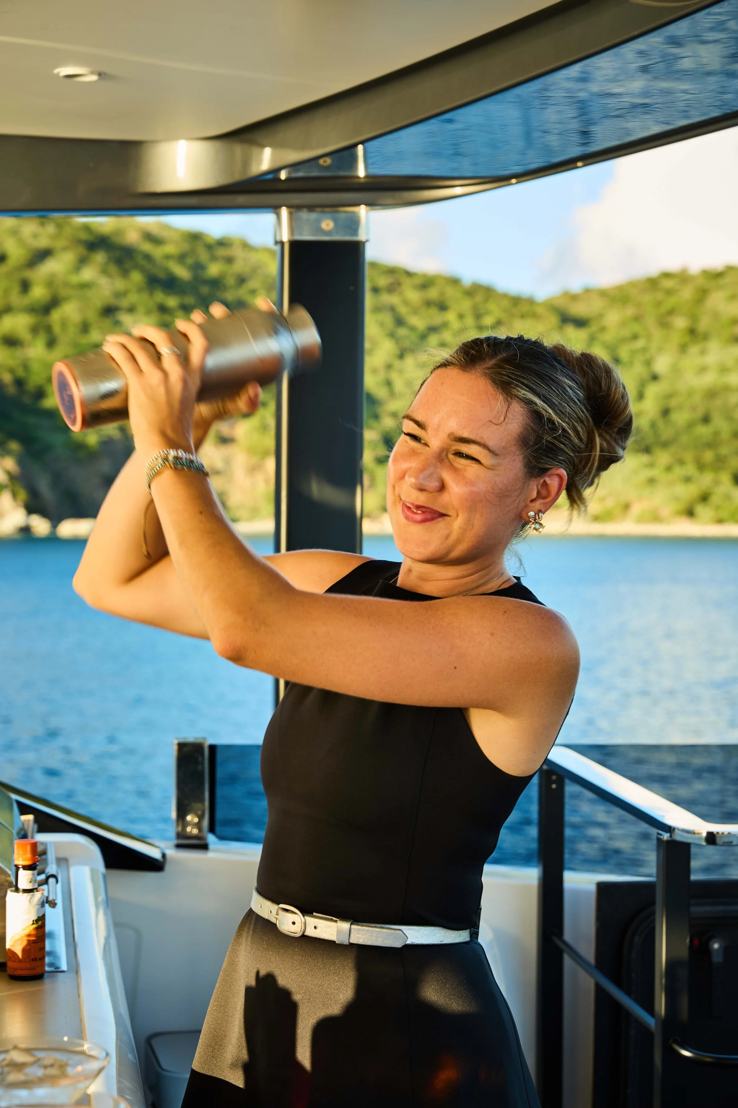 Open beach club onboard a luxury yacht with sunlight reflecting on the water