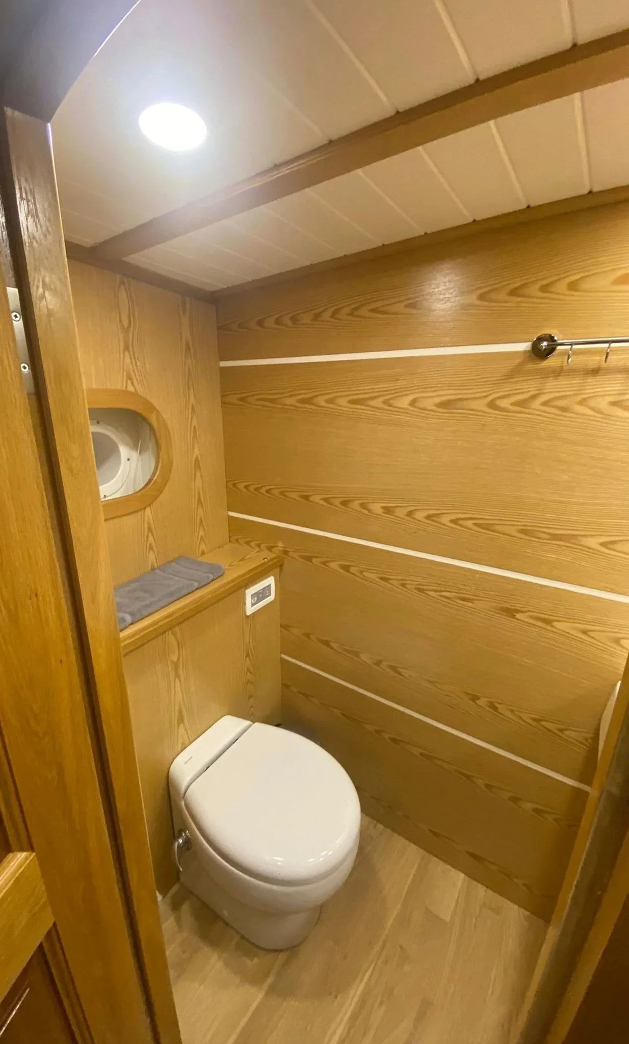 Compact gulet bathroom with wooden panel walls