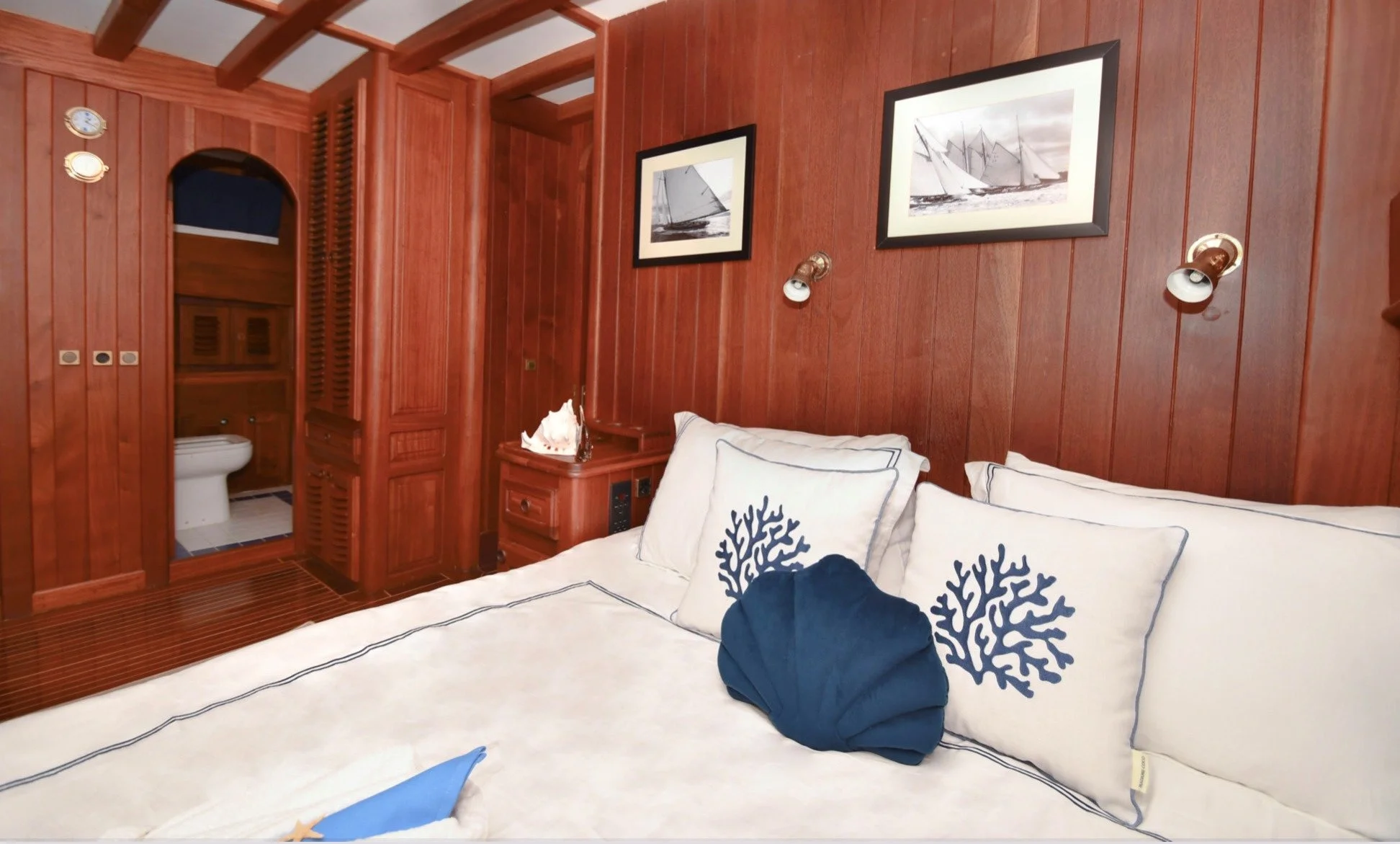 Nautical bedroom cabin inside a traditional private gulet.