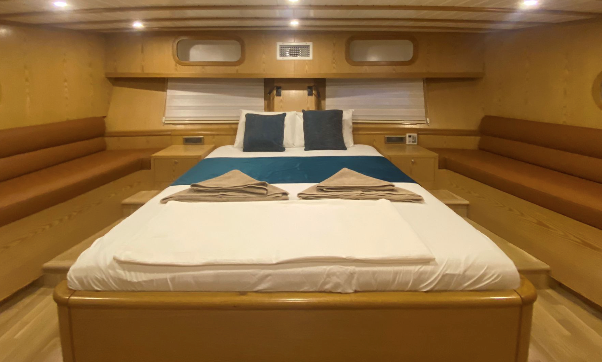 Cozy private gulet bedroom with folded towels