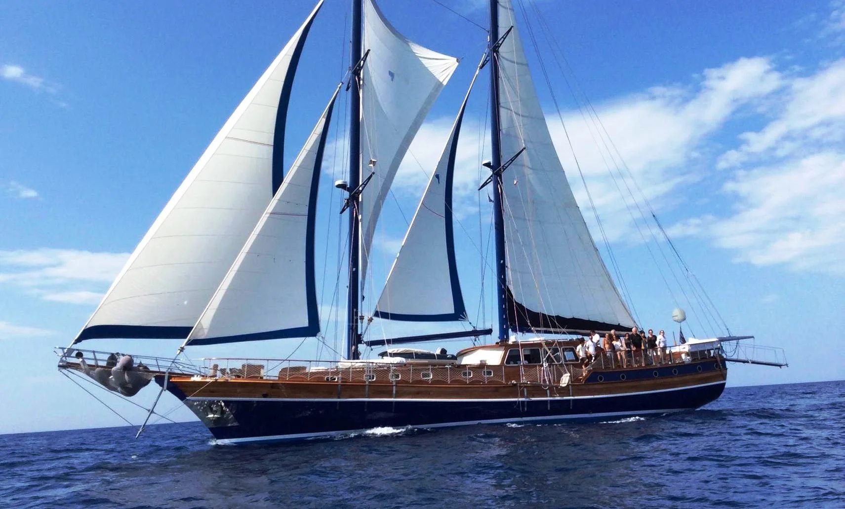 Large sailing gulet with guests on deck near Bodrum.