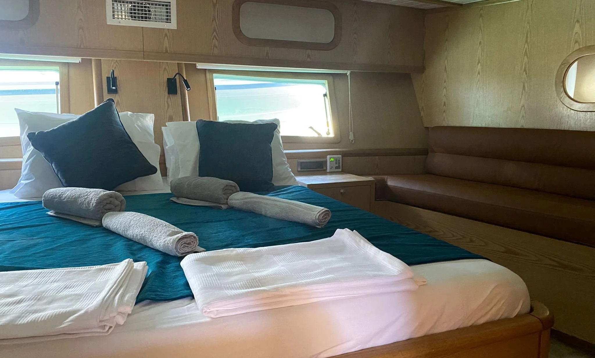 Private gulet bedroom with teal bedding and rolled towels