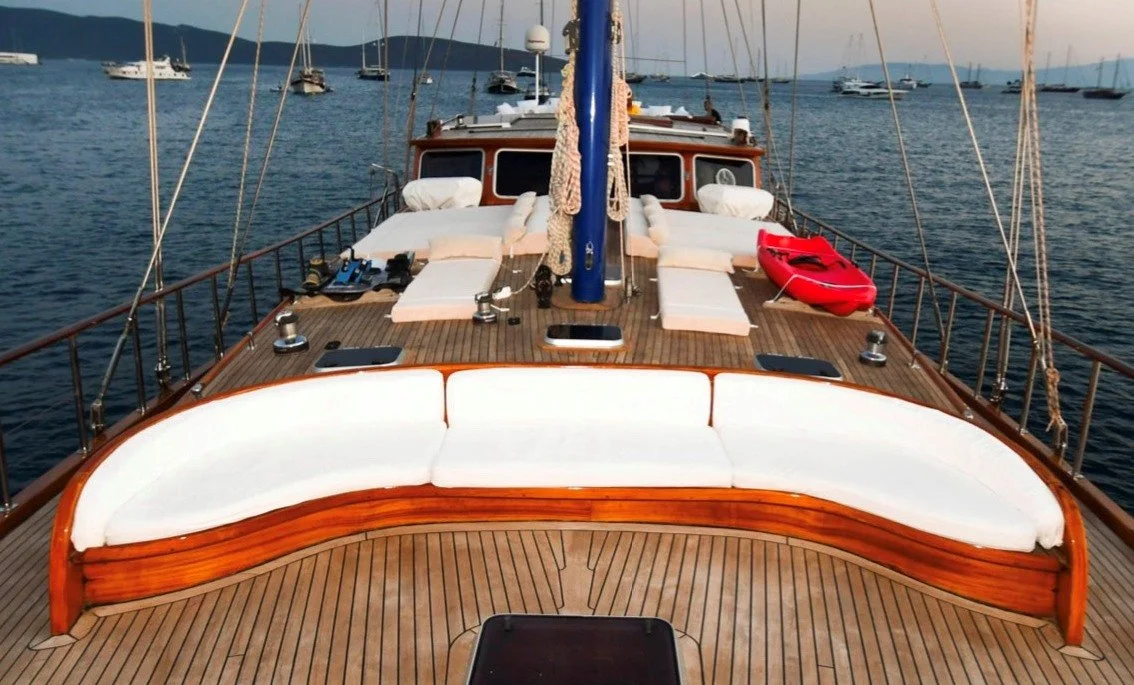 Private gulet deck with lounge seats and calm water.