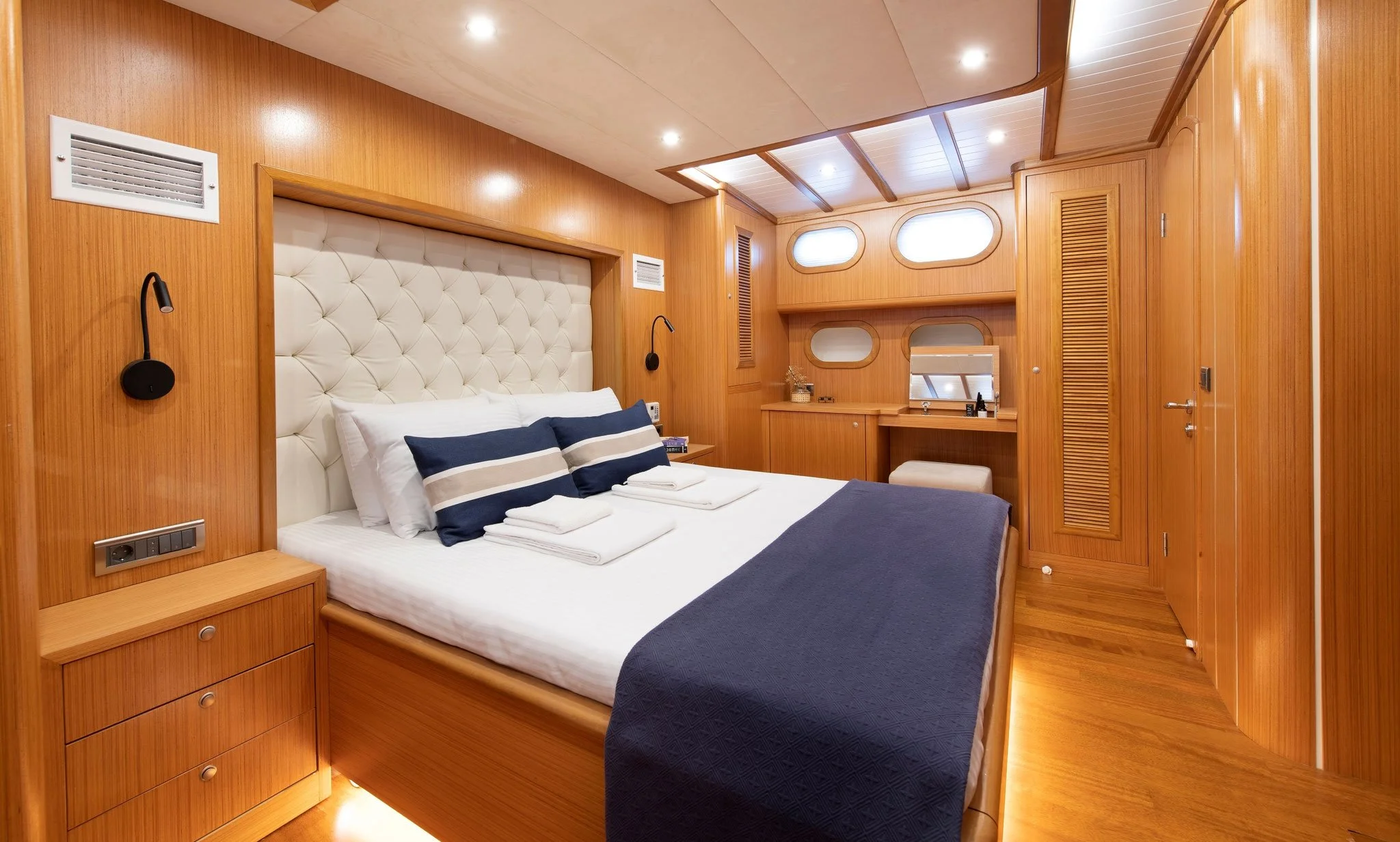 Cozy private gulet bedroom with wooden interior.