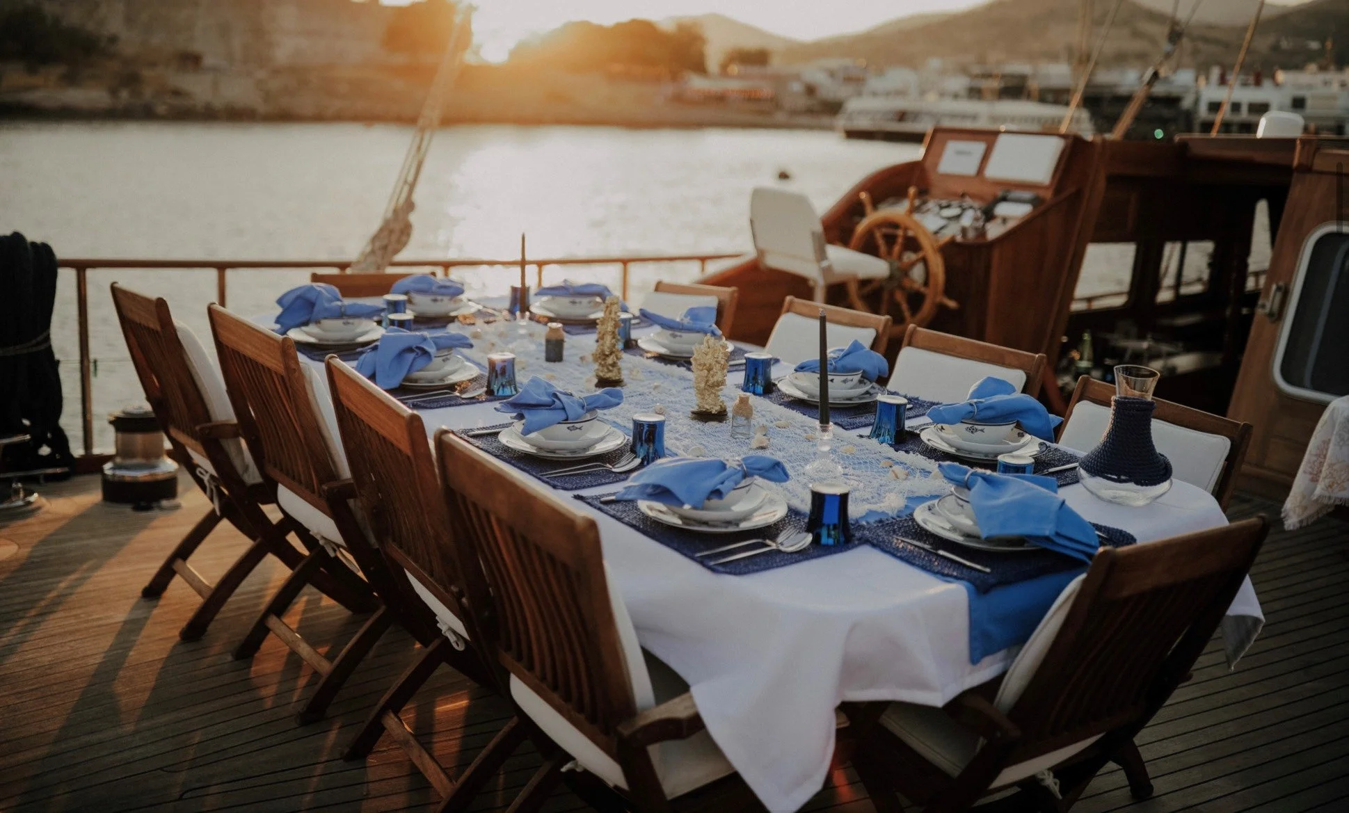 Gulet deck dinner setup during sunset in Bodrum.