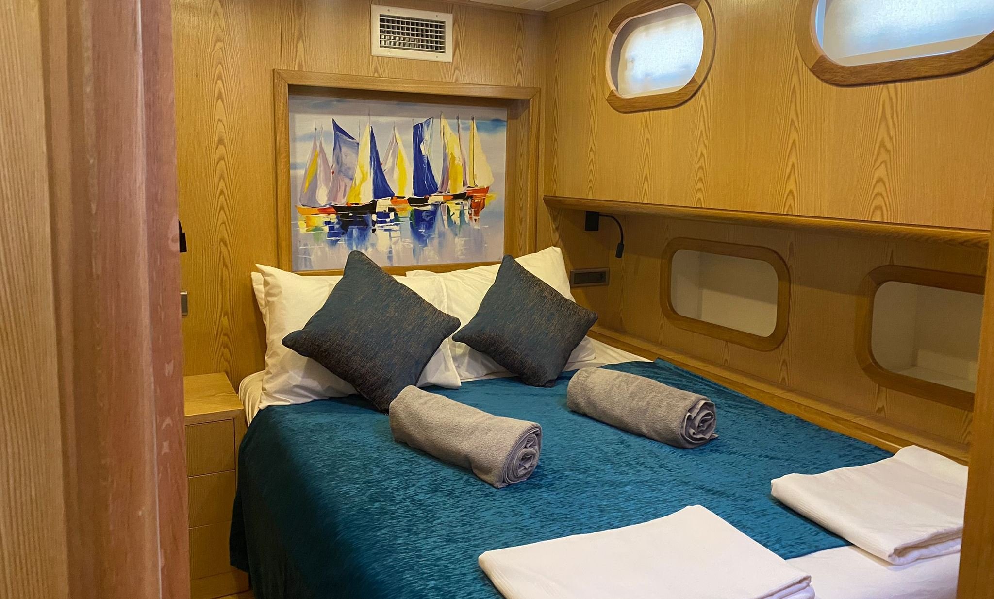 Cozy private gulet bedroom with blue bedding