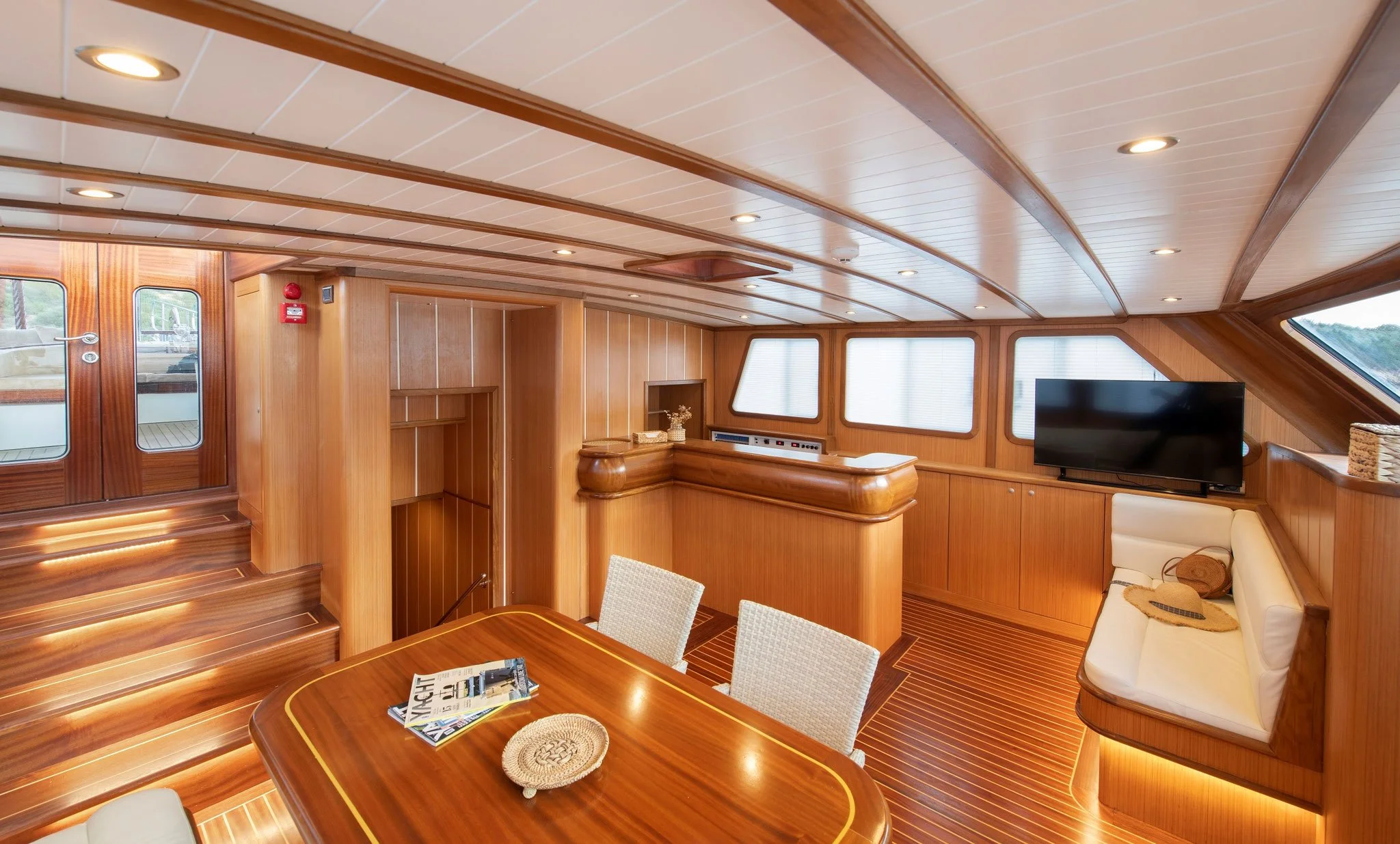 Private gulet cabin lounge with wooden interior.