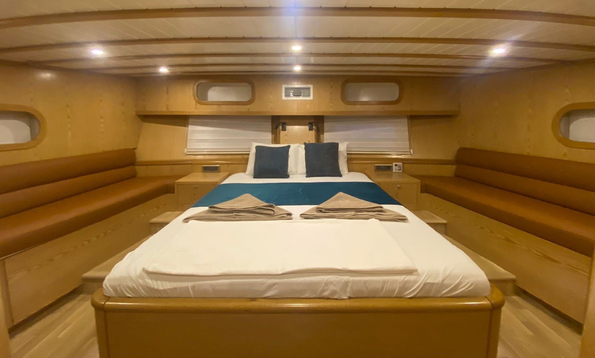Cozy private gulet bedroom with warm wooden walls