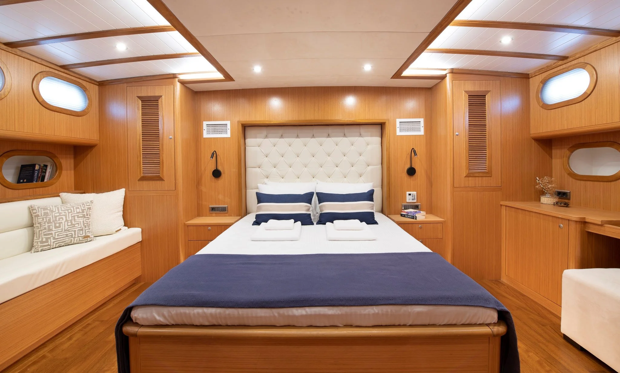 Private gulet cabin bedroom with wooden interior.