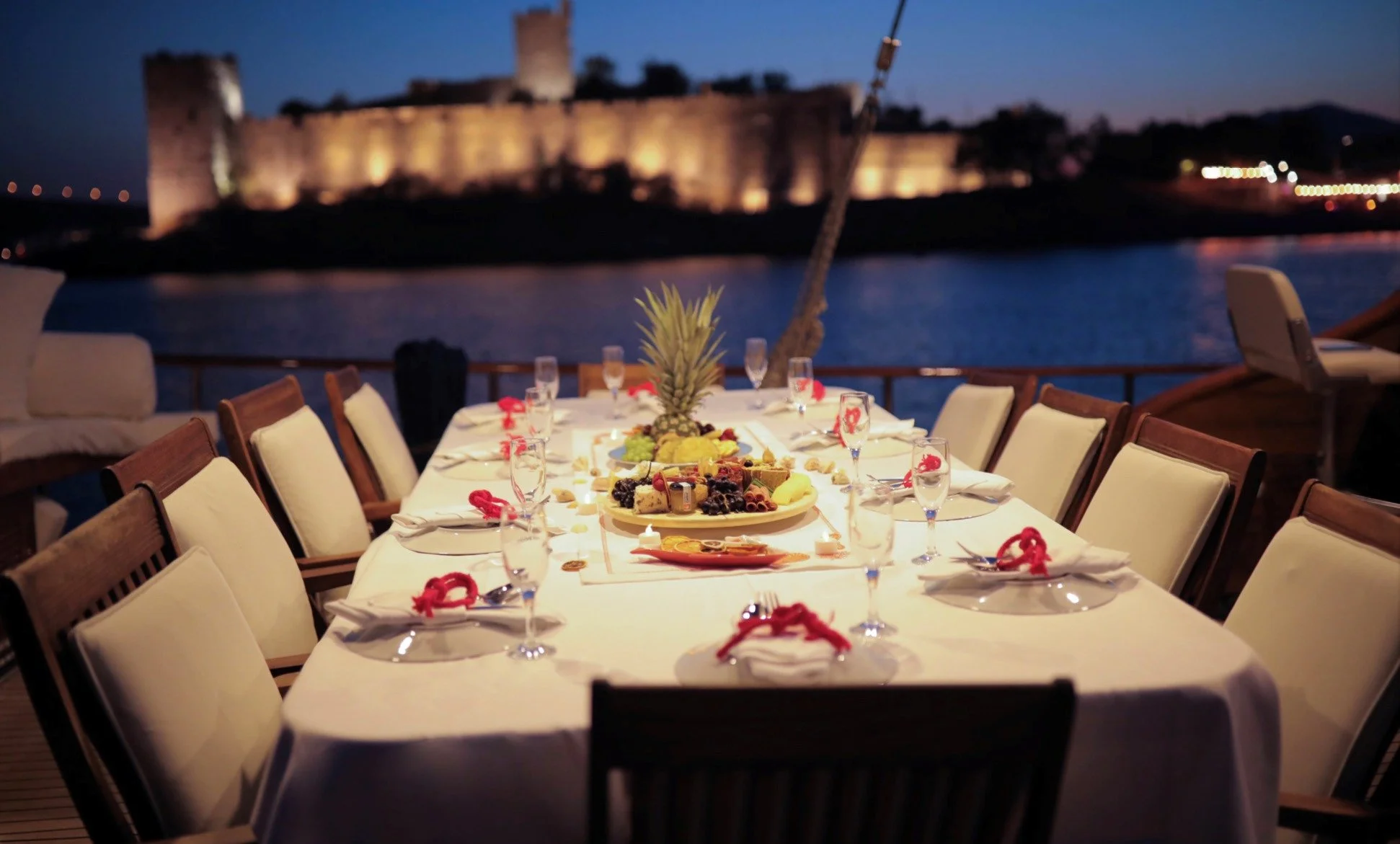 Dinner setup on a private gulet with Bodrum Castle view.