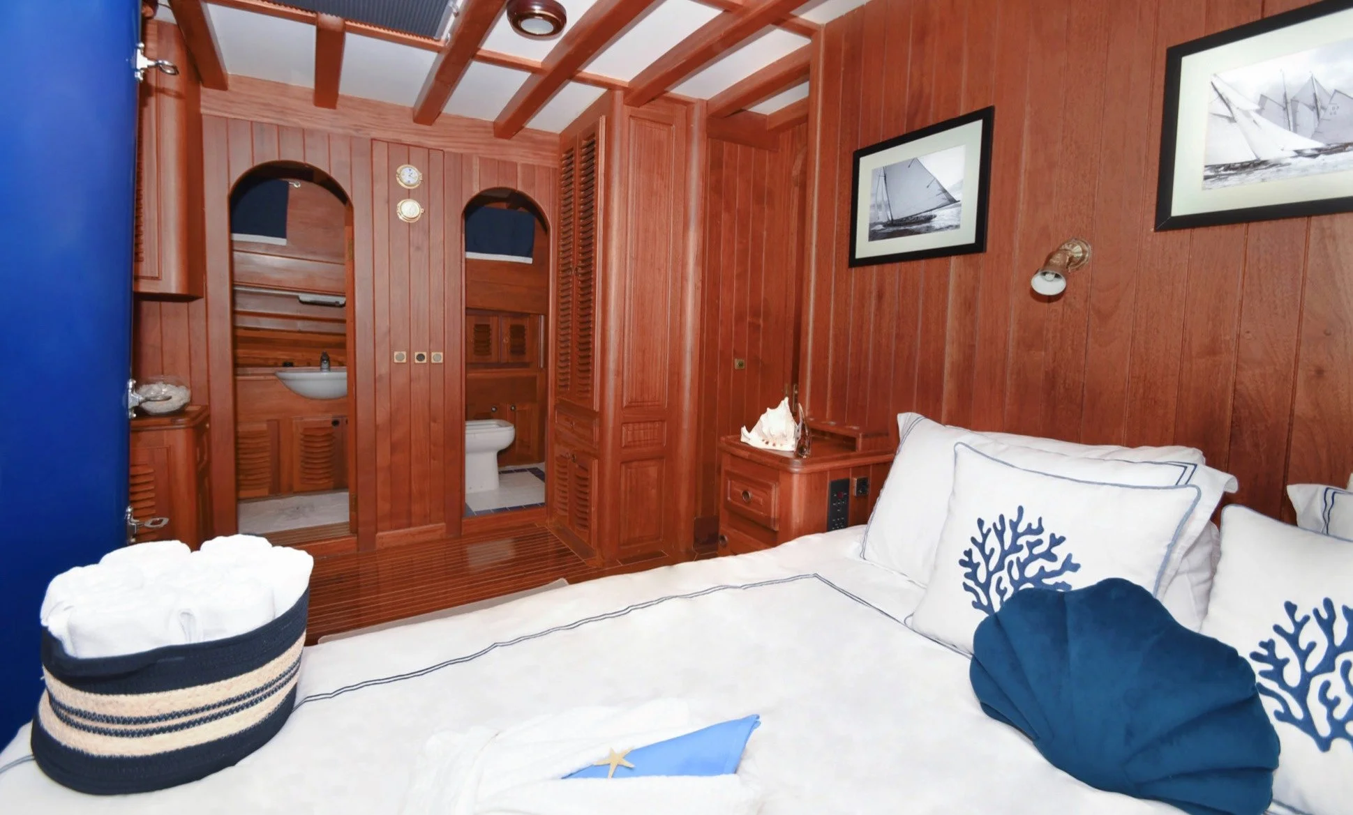 Cozy gulet bedroom with nautical details.