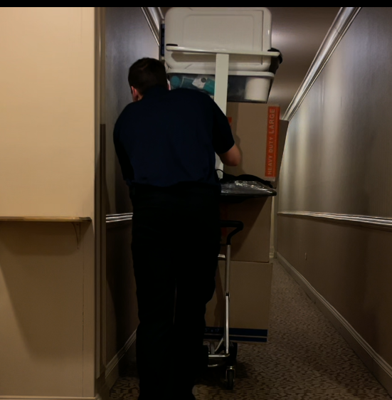 True Movers Professional moving full cart down apartment hallway to maximize efficiency