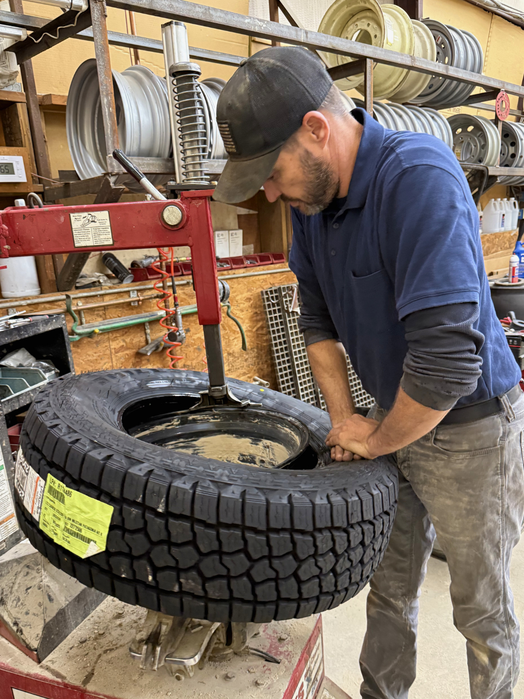 Stanley Heckman, owner of CSH Trailers & Automotive Services in Westphalia, Missouri, changing a tire