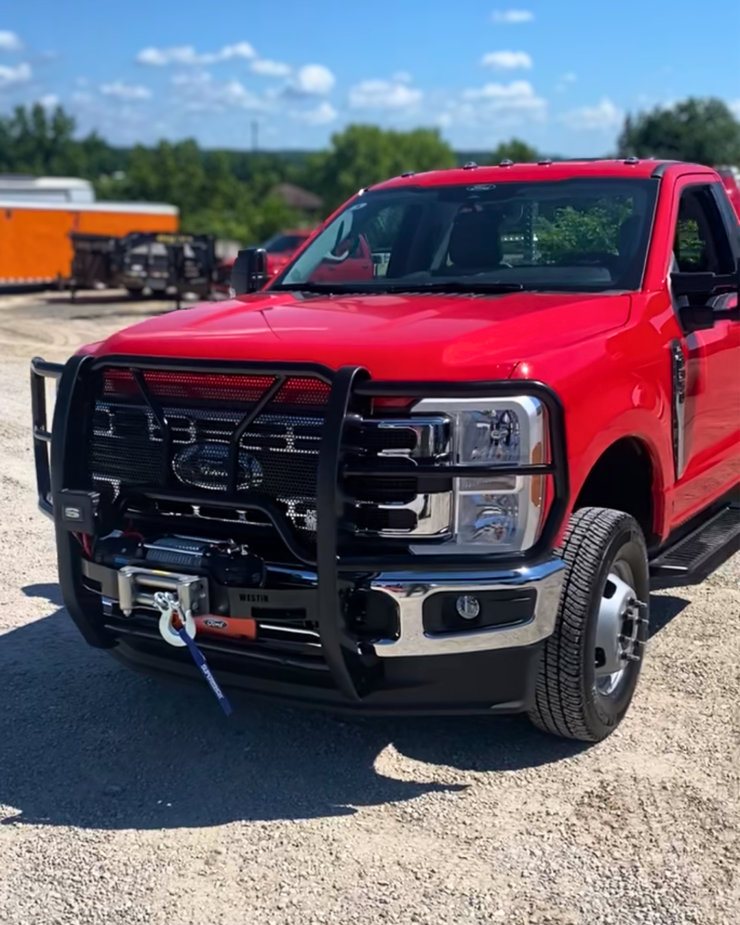 Red truck with a grill guard and winch, installed at CSH Trailers & Automotive Services in central Missouri