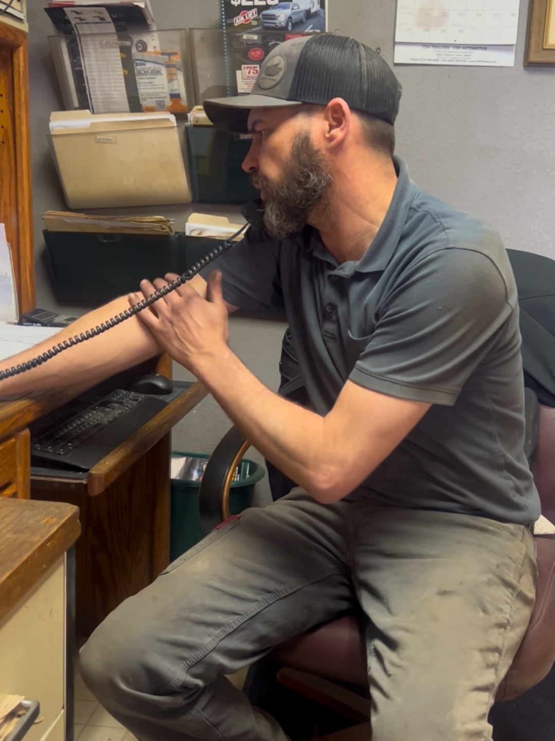 Stanley Heckman, owner of CSH Trailers & Automotive Services in Westphalia, Missouri, talking to a customer on the phone